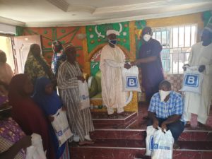 The Group Head, Media Relations Office of Julius Berger Plc, Prince Moses Duku, presents the JBN food palliatives to the Kagini community through their King, Seriki Alh. Isah Jemutu Gbegbe in Abuja last Wednesday.
