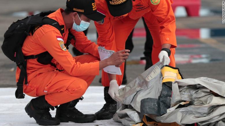 Rescuers inspects debris found in the waters around the location where a Sriwijaya Air passenger jet has lost contact.